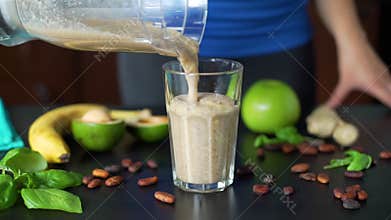 Woman Pouring Smoothie from Blender into Glass