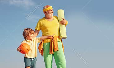 Different generations. Like sports. Joyful old-aged man and cute little boy practicing sport and healthy lifestyle over