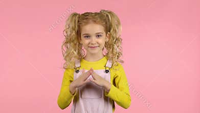 Lovely blond curly girl is clapping her hands