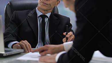 Thoughtful businessman in suit listening to company partner, deal negotiation