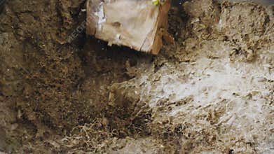 Wastepaper falls down into hot liquid cellulose slow motion