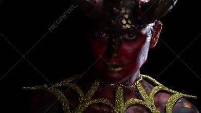 Succubus with big red eyes and scaly skin is standing in a dark room slow motion