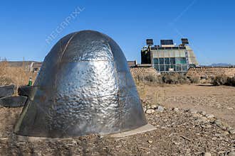 Earthship Biotecture home behind sculpture