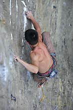 Rock climber clings to a rock