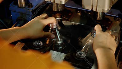 Making or blowing plastic bottles using manufacturing equipment and manual labor