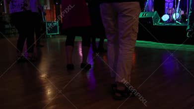 Seniors line dancing in community hall