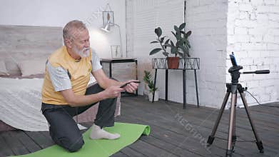 Influencers blogger, old man takes review of smart watches for vlog recommending to his audience of subscribers a device