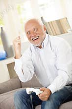 Senior man winning on computer game