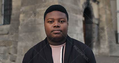 Guy looking to camera with serious face.