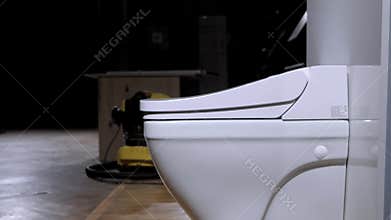 White automatic toilet. Modern technological solution. Raising the lid and rim of the toilet