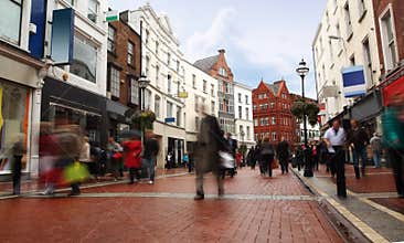 People quickly going on small, narrow street