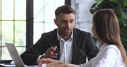 Smiling male banker consult female client make deal sign agreement