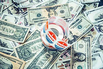 I vote Today stickers on a pile of American dollar bills, political election concept of economy and democratic elections in the
