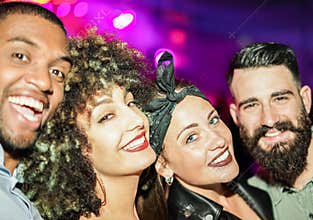 Happy friends taking selfie  in night club dance floor - Young people enjoying weekend nightlife and having fun together - Soft