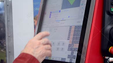 Person works behind the control panel of the production machine