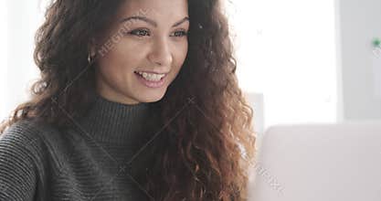 Happy woman using laptop at office