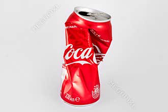 KIEV, UKRAINE - 25 June 2019: 330ml Coca cola crumpled can on white background.
