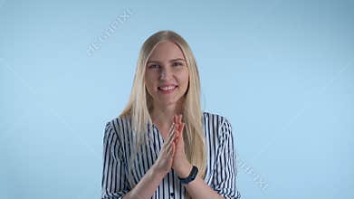 Portrait of smiling young lady giving applause to somebody.
