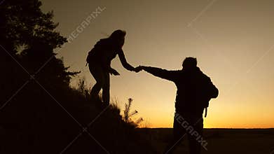 Travel and adventure concept. male traveler and female traveler descend from top of the hill. teamwork of business