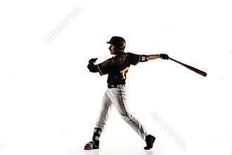 Baseball player, pitcher in a black uniform practicing on a white background.