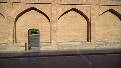Iranian people walking over SioSePol or Bridge of 33 arches, one of the oldest bridges of Esfahan, Iran