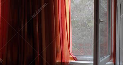 Open window with moving curtain