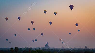 Hot air balloons at sunrise over the pagodas and temple area