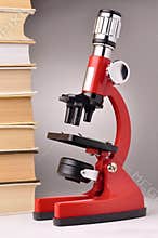 Books and red microscope