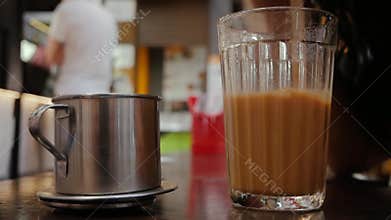 Hand stirs Vietnamese coffee