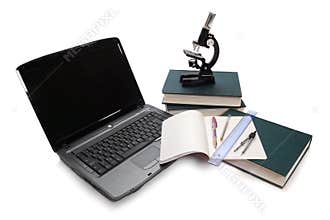 Laptop, microscope and books.