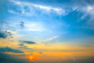 Panorama bright sunset with blue sky, white clouds and red sun
