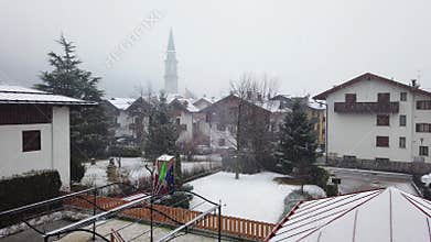 Heavy snow falling in little italian village Pinzolo trentino alto adige Italy