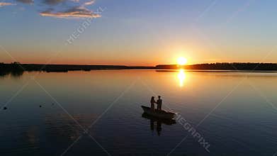 People in the Rowing Boat. Sunset on a Lake or River - Drone Footage