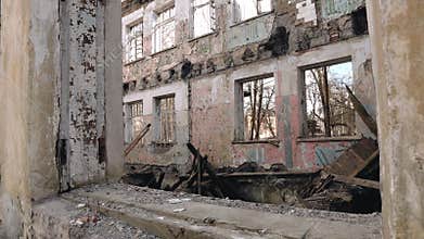 A bombed-out abandoned building with a broken roof and walls
