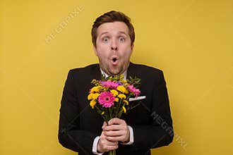Surprised man with flowers for his girlfriend proposing to be his wife