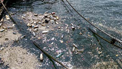 Plastic bottles, bags, wastes floating in water. Sea ocean water pollution concept. Plastic pollution crisis
