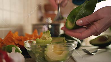 Making guacamole for a tortilla chips snack - closeup