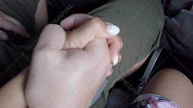 Young couple holding hands nervous during plane take-off. Aircraft shaking in turbulence zone