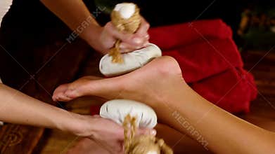 Foot massage by thai ball compress.