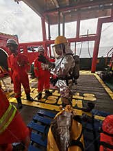 Marine  crews conduct fire drill on board ship