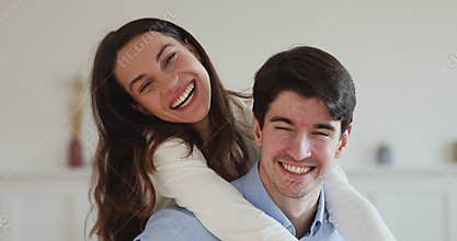 Young couple with dental smiles laughing together looking at camera