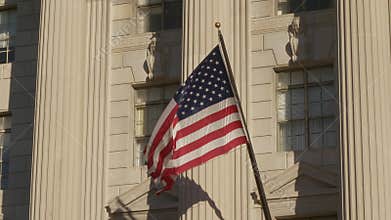 USA flag on facade of US Commerce building in Washington DC