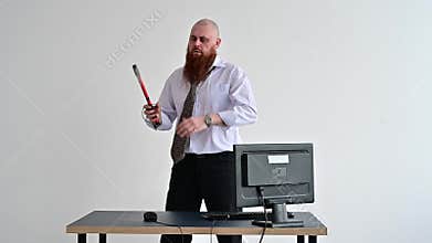 Stressed crazy businessman smashing his computer in office using ax problem concept. The man has problems at work and
