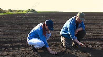 TWO YOUNG FARMERS ANALYZING THEIR LAND