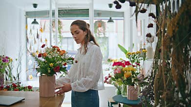 Flower store retailer work make bouquet in beautiful spring plant shop business.