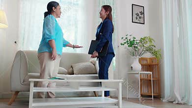 Agent insurance life or health or adviser young asian businesswoman appointment and visit with elderly woman.