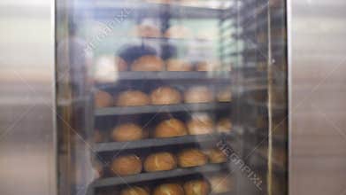 Bread in bakery oven turning in the hot air