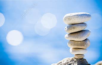 Stones balance, pebbles stack over blue sea in Croatia.