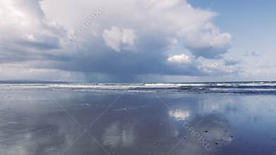 Atmospheric serene empty beach scene with cloudy sky, in Essaouira, Morocco.