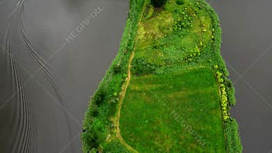 Flight over the peninsula. View of fields and meadows.